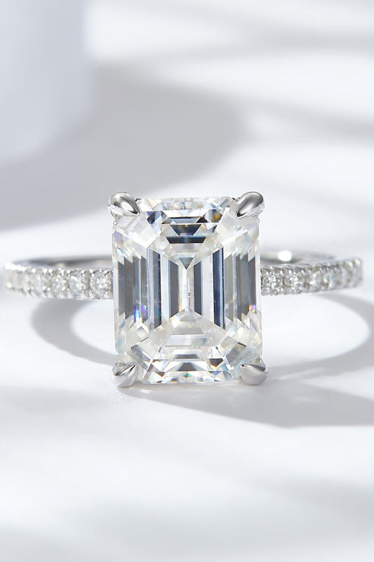 4 carat moissanite ring emerald cut with a sparkling band and a clear stone, perfect for engagement or special occasions.
