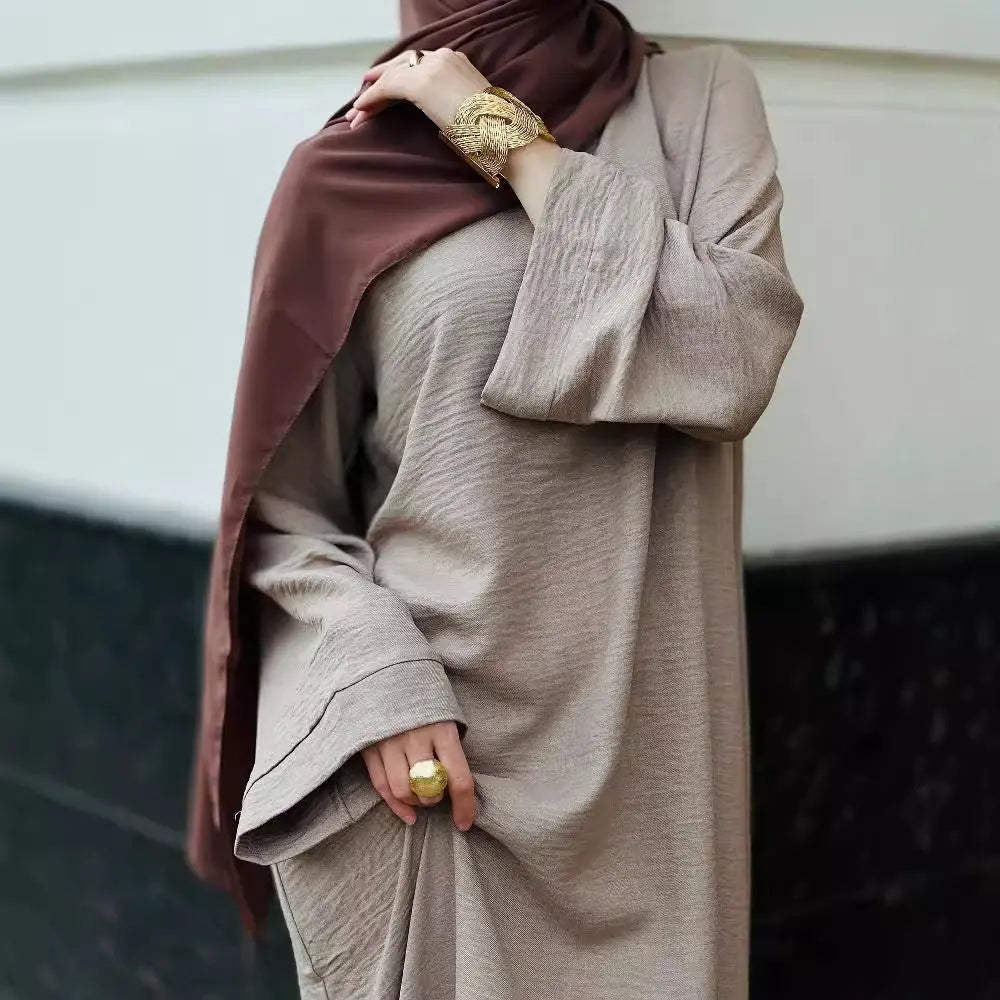Elegant purple abaya from the abaya and scarves collection for women, featuring stylish buttons and a modern design.