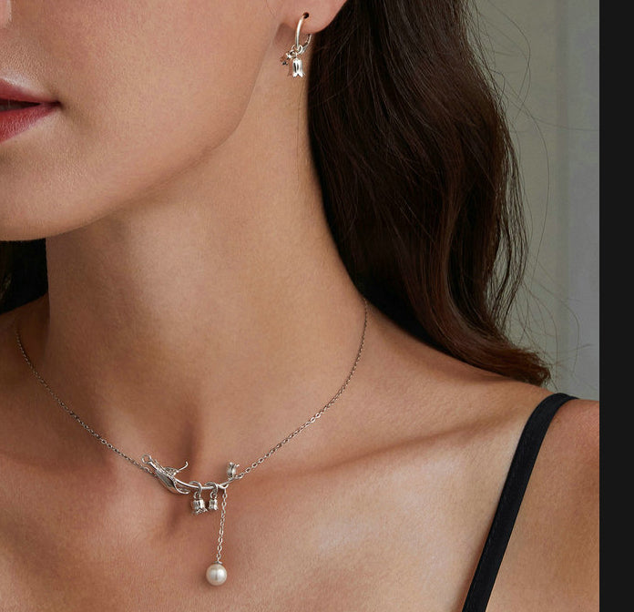 "Girl wearing  Sterling Silver Necklace earrings with white stones"