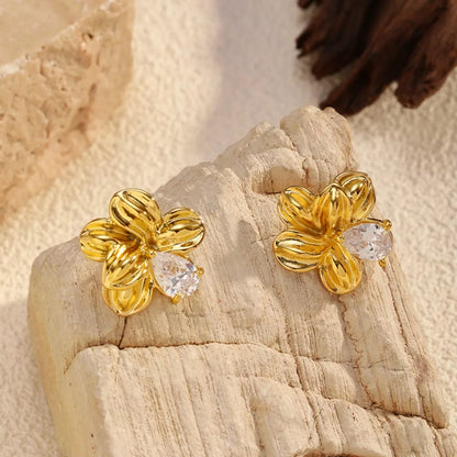 "Close-up of 18K gold-plated botanical flower stud earrings"