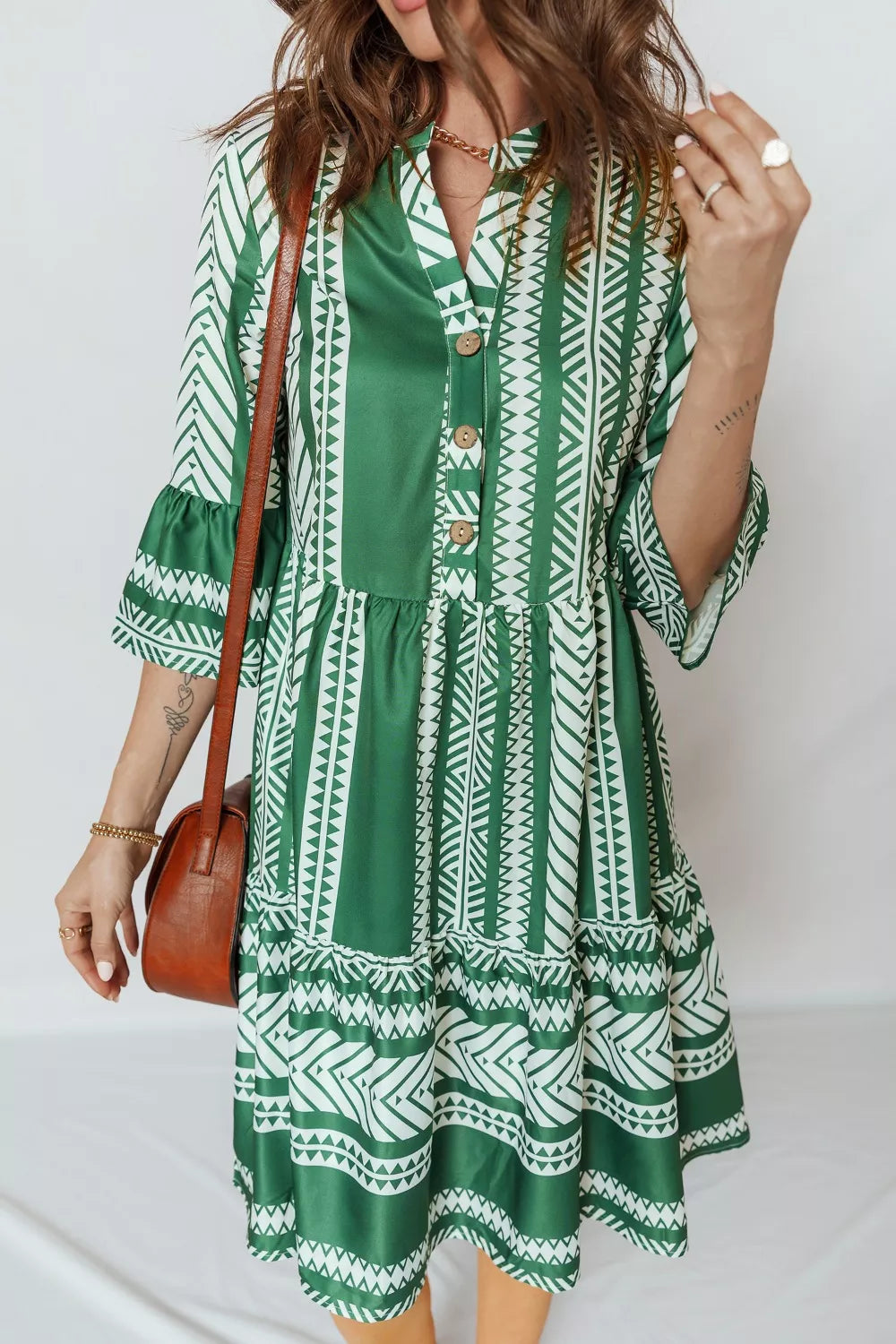 Woman wearing boho chic printed half button casual dress back view