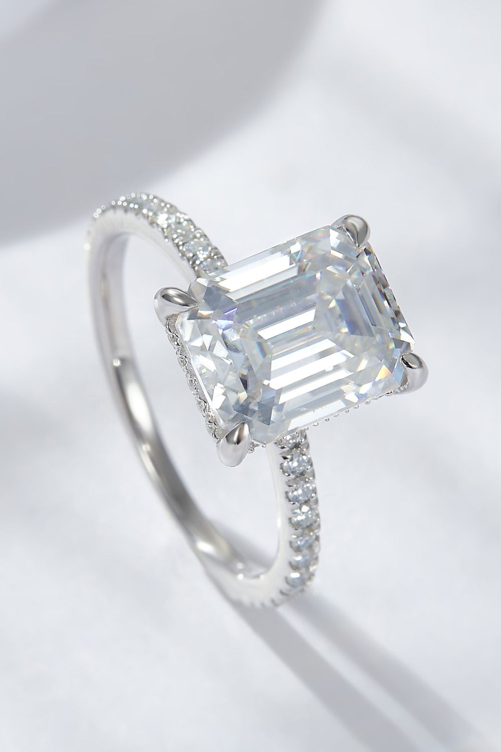 4 carat moissanite ring emerald cut with sparkling band, showcasing its brilliance and elegance.