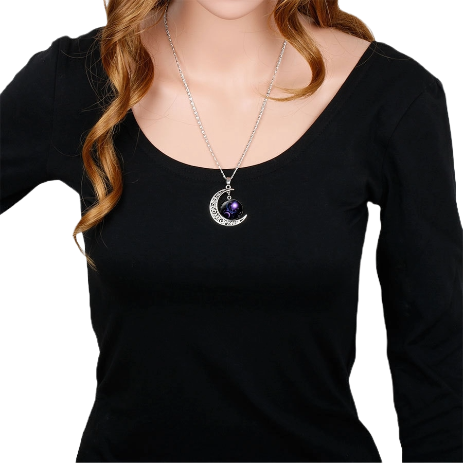 Zodiac sign pendant necklace worn with black long-sleeve top"