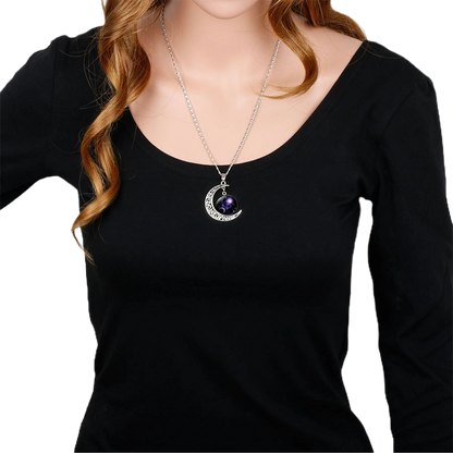 Zodiac sign pendant necklace worn with black long-sleeve top"