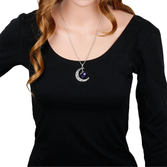 Zodiac sign pendant necklace worn with black long-sleeve top"