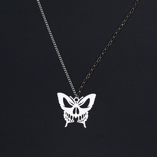Gothic silver butterfly pendant necklace with detailed wing design on black background"
