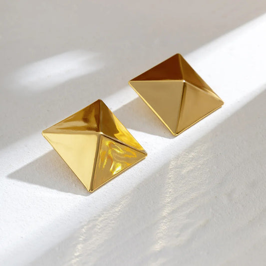 3D geometric Stud Earrings in gold finish on white background