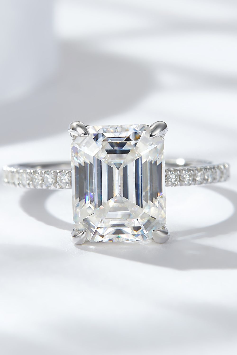 4 carat moissanite ring emerald cut with a sparkling band and a clear stone, perfect for engagement or special occasions.