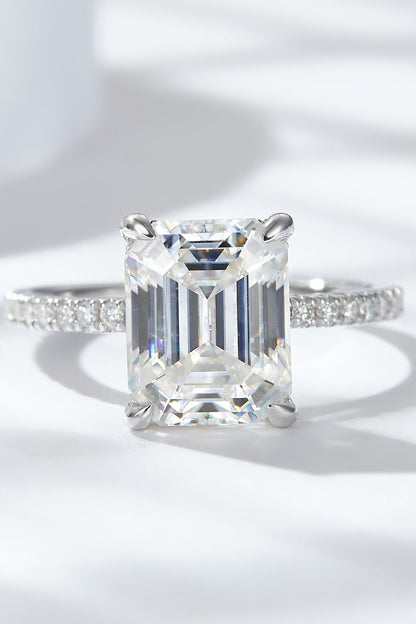 4 carat moissanite ring emerald cut with a sparkling band and a clear stone, perfect for engagement or special occasions.