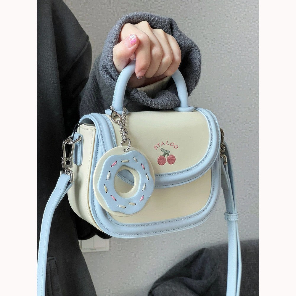 Hand-held shoulder saddle bag