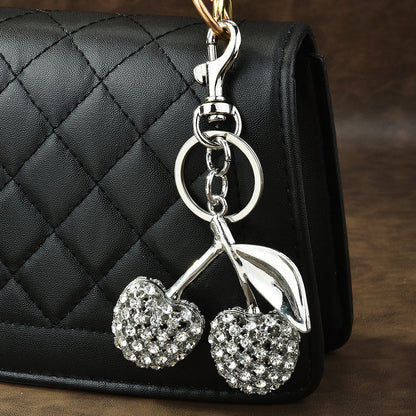 White crystal cherry shaped keychain with silver accents - elegant bag charm accessory