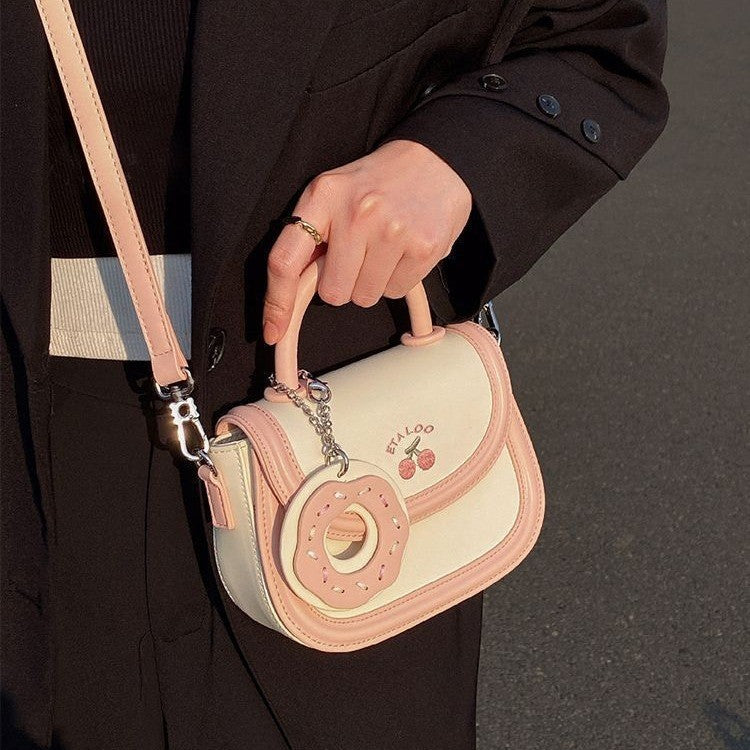 Hand-held shoulder saddle bag